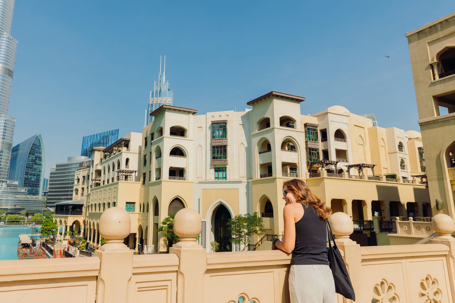 Middle Eastern Woman Contemplating Scenic View of Dubai Downtown Cityscape